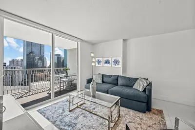 a living room with a couch and a large window at High Floor Ocean view Unit In Brickell in Miami