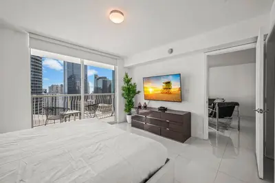 a bedroom with a large bed and a large window at High Floor Ocean view Unit In Brickell in Miami
