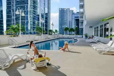 a group of people in the pool at a hotel at Amazing location W Parking in Miami in Miami