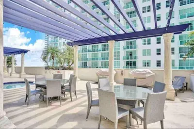 a patio with a table and chairs and a building at Amazing location W Parking in Miami in Miami