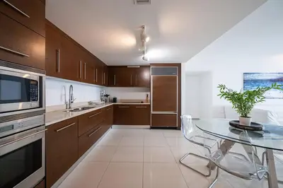 a kitchen with a glass table with a potted plant at Iconic Icon W Unit - Pool & Ocean Views in Miami