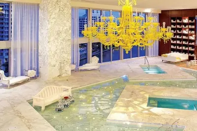 a living room with a chandelier and a pool at Iconic Icon W Unit - Pool & Ocean Views in Miami