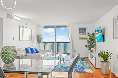 a living room with a couch and a glass table at INCREDIBLE OCEAN VIEW 3 BEDROOMS UNIT in Miami