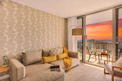 a living room with a couch and a balcony at Infinite View - Balcony- Amazing Pool- Near Beach in Hallandale Beach