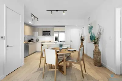 a kitchen and dining room with a table and chairs at Infinite View - Balcony- Amazing Pool- Near Beach in Hallandale Beach