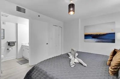 a girl laying on a bed in a bedroom at Modern 2/2 with Beautiful Ocean and Brickell Views in Miami