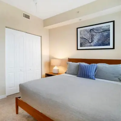a bedroom with a large bed with a wooden headboard at Beautiful Apartment with Pool in Miami in Miami