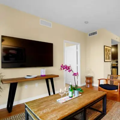 a living room with a table and a flat screen tv at Beautiful Apartment with Pool in Miami in Miami