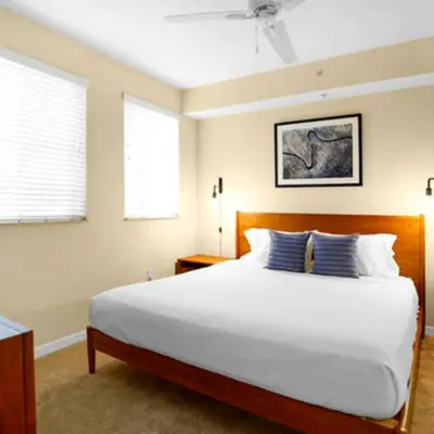 a bedroom with a large white bed with blue pillows at Beautiful Apartment with Pool in Miami in Miami