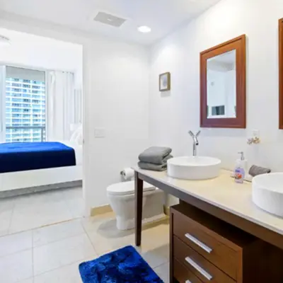 a bathroom with two sinks and a toilet at Vacation Apartment for Couples in Miami in Miami