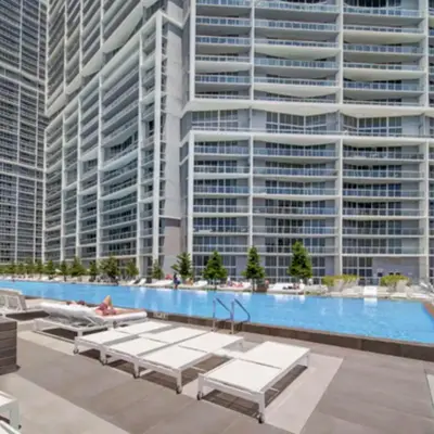 a swimming pool with tall buildings in the background at Vacation Apartment for Couples in Miami in Miami