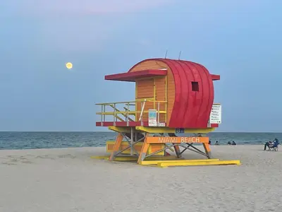 a lifeguard tower on a beach with the ocean at Beachfront Apt in Carlyle Hotel on Ocean Drive in Miami Beach