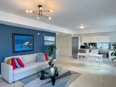 a living room with a white couch and a table at Beachfront Apt in Carlyle Hotel on Ocean Drive in Miami Beach