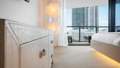 a bedroom with a bed and a large window at Ocean View Private Residence at South Beach - 804 in Miami Beach