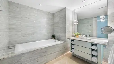 a bathroom with a tub and a sink at Ocean View Private Residence at South Beach - 804 in Miami Beach