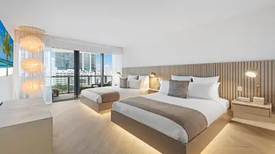 a hotel room with two beds and a balcony at Ocean View Private Residence at South Beach - 804 in Miami Beach