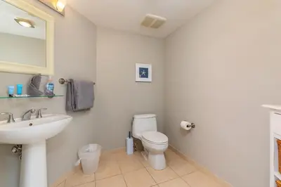a white bathroom with a sink and a toilet at 16699 Collins Ave Unit 2906 in La Perla in Miami Beach