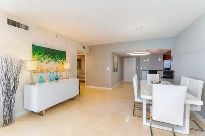 a kitchen and dining room with a table and chairs at 16699 Collins Ave Unit 2906 in La Perla in Miami Beach