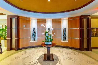 a lobby with a vase of flowers on a table at 16699 Collins Ave Unit 2906 in La Perla in Miami Beach