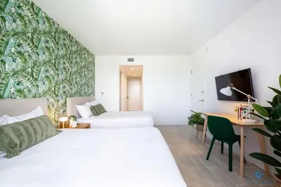 a bedroom with two beds and a desk with a computer at Tropical Apartment - Balcony - Resort with Pool and Gym in Hallandale Beach