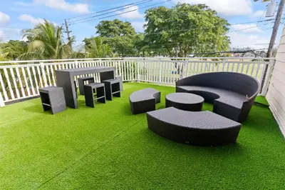 a group of chairs and tables on a balcony at UPSCALE MANSION IN THE HEART OF MIAMI WITH POOL in Miami
