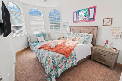 a bedroom with a bed and a tv and windows at UPSCALE MANSION IN THE HEART OF MIAMI WITH POOL in Miami