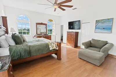 a bedroom with a bed and a chair and a television at UPSCALE MANSION IN THE HEART OF MIAMI WITH POOL in Miami