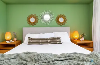a bedroom with a bed with two mirrors on the wall at Tropical Apartment with Balcony - Pool - Up To 4 - Gym in Hallandale Beach