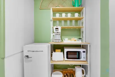 a kitchen with a white refrigerator and a microwave at Tropical Apartment - Balcony - Resort, Pool - Gym in Hallandale Beach