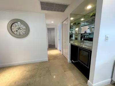 a hallway with a clock on a wall at Breathtaking ocean view! 15th floor in Miami Beach