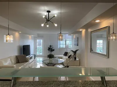 a living room with a couch and a glass table at Breathtaking ocean view! 15th floor in Miami Beach