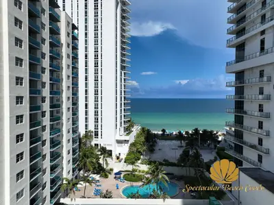 a view of the beach from the balcony of a building at Oceanfront Luxury Condo - Private Beach Access, Pool & Game Room in Hollywood