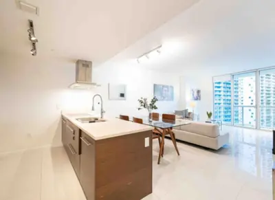 a kitchen and living room with a sink and a couch at Vacation Apartment in Miami in Miami