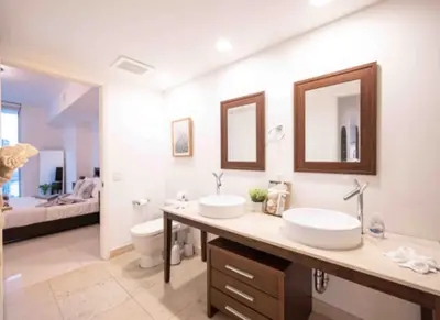 a bathroom with two sinks and a toilet at Vacation Apartment in Miami in Miami