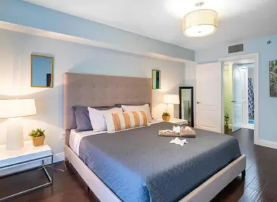 a bedroom with a large bed and two lamps at Modern Vacation Apartment in Miami in Miami