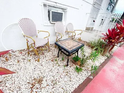 a group of chairs and a table on a patio at Small House Near Airport Beach - Wynwood in Miami