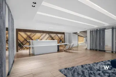 a living room with a white table and a wooden floor at 1 BR at Fort Lauderdale in Fort Lauderdale
