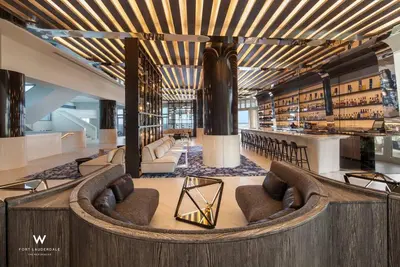a lobby with a library with couches and chairs at 1 BR at Fort Lauderdale in Fort Lauderdale