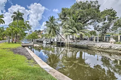 a body of water with trees and a bench at Canal-Front Condo Walk to Downtown Ft Lauderdale! in Fort Lauderdale