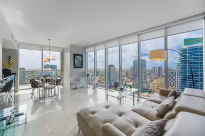 a living room with a couch and a table at Wonderful 2/2 Condo at Icon Brickell With Pool in Miami
