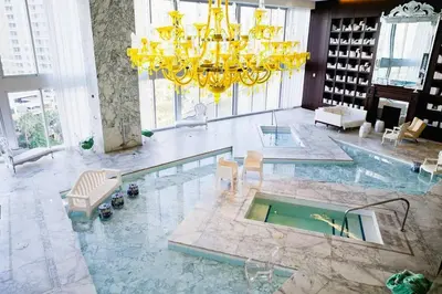 a large room with a pool and a chandelier at Wonderful 2/2 Condo at Icon Brickell With Pool in Miami