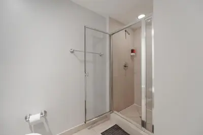 a shower with a glass door in a bathroom at Wonderful 2/2 Condo at Icon Brickell With Pool in Miami