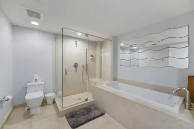 a bathroom with a tub and a shower and a toilet at Wonderful 2/2 Condo at Icon Brickell With Pool in Miami
