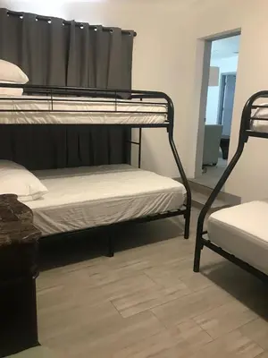 a room with two bunk beds and a window at Bekahouse Hostel with parking, backyard and laundry in Miami