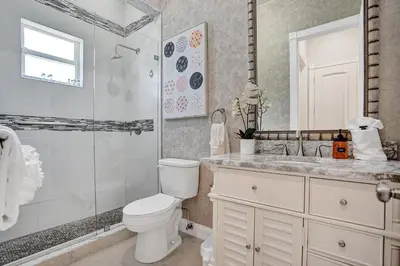 a bathroom with a toilet and a shower and a sink at Villa wpool mini-golf firepits in Davie