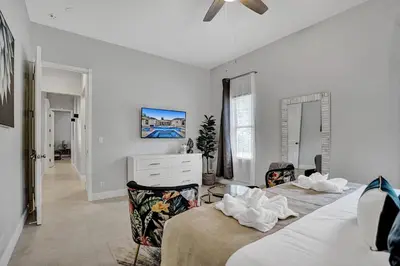 a white bedroom with two beds and a dresser at Villa wpool mini-golf firepits in Davie