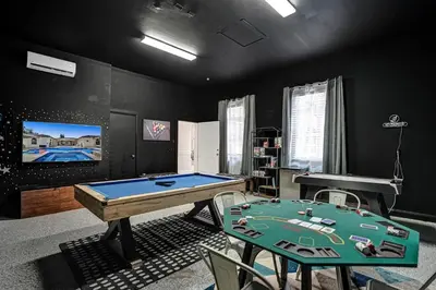 a room with a pool table and a tv at Villa wpool mini-golf firepits in Davie