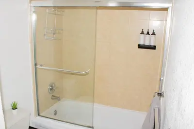 a shower with a glass door in a bathroom at Hollywood Beachfront Condo, Steps to Ocean, Pool & Game Room in Hollywood