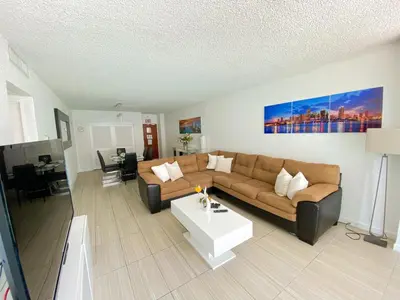 a living room with a couch and a coffee table at Hollywood Beachfront Condo, Steps to Ocean, Pool & Game Room in Hollywood