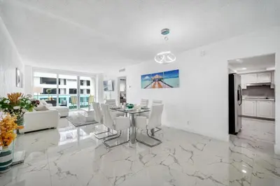 a dining room and living room with a table and chairs at Hollywood Beach Ocean View Condo, Direct Beach Access, Pool & Resort Amenities in Hollywood